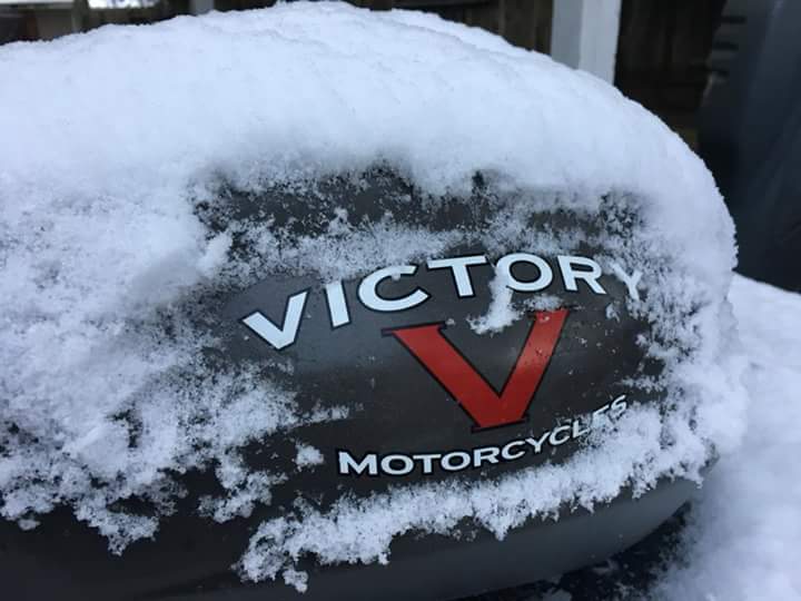 Victory motorcycle gas tank covered in snow