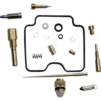 The Yamaha Carburetor Repair Kit by Shindy includes a main jet, various small metal parts, screws, jets, springs, washers, and a black rubber gasket arranged neatly on a white background.