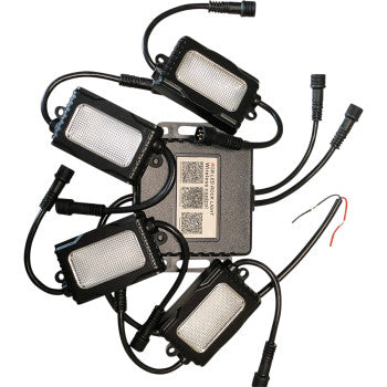 The LED Rock Light Kit by Brite-Lites includes five small rectangular aluminum lights with black casings, all linked to a labeled central control box with QR codes and two wires for easy installation.