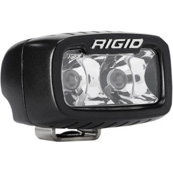 Close-up of a black SR-M PRO Light Spot by Rigid Industries, showcasing its durable cast aluminum housing, clear front with two bulbs and reflective surfaces, mounted on a compact metallic bracket.