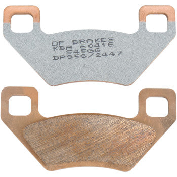 The Arctic Cat Standard Brake Pads by Dp Brakes include two sintered metal pads with copper-colored edges and twin square mounting holes, showing both the friction surface with stamped text and a worn side for fade-free performance.