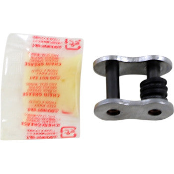 The 520 Max Z Connecting Link Rivet Nickel by RK, a small metal motorcycle chain link with two pins and a rubber O-ring, is pictured next to its sealed chain grease packet.