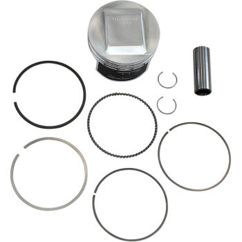 Silver metallic piston with flat top and grooves, black and silver piston rings, two small silver circlips, and a.