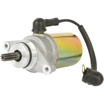 The Starter Motor by Parts Unlimited features a metallic cylindrical body, gear protrusion, copper bushings, mounting holes, and attached black wiring with a rubber cap.