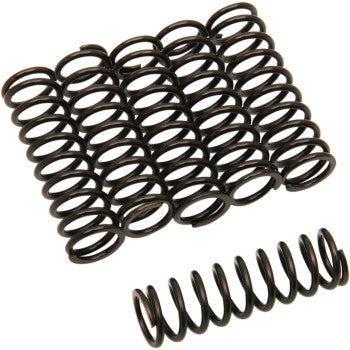 Nine Clutch Springs by Barnett are arranged in a grid, with one identical coil spring positioned in front of the group, all displayed on a white background.