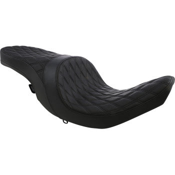 Black low profile motorcycle seat with smooth quilted vinyl surface and contoured ergonomic shape.