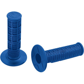 Two Flange Style Stealth MX Grips in blue by Moose Offroad, with flared ends, textured surface for traction, and "MOOSE RACING" embossed on the side. One stands upright; the other lies flat. Made in the USA.