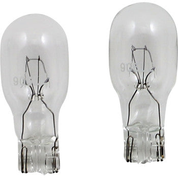 Two Peak Lighting Miniature Bulb 906 clear glass automotive bulbs stand upright side by side, filaments and metal bases visible against a white background—quality bulbs designed to meet OE specifications.
