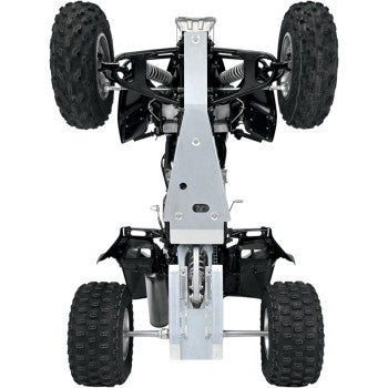 The Honda Skid Plate by Motorsport Products is shown installed on an ATV from underneath, highlighting its durable aluminum engine protection along with the ATV’s robust suspension and four knobby tires.