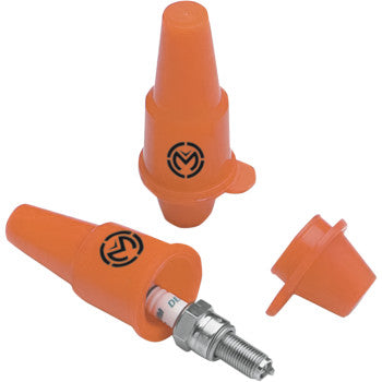 Two orange Spark Plug Carriers by Moose Offroad—one with a spark plug inside, one empty—feature black circular logos on the sides, plus a separate cap nearby for spare spark plug protection.