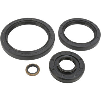 Four black rubber seals from the Kawasaki - Suzuki Differential Seal Kit Front by Moose Offroad, in assorted sizes, are placed on a light background. These smooth-edged seals are ideal for high-speed EMQ bearings in machinery.