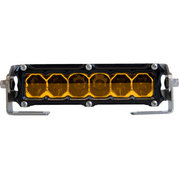 The Light Bar 6" Flood Spot Amber by Heretic features a black housing, amber lens, six individual light segments, and is mounted on two stainless steel mounts.