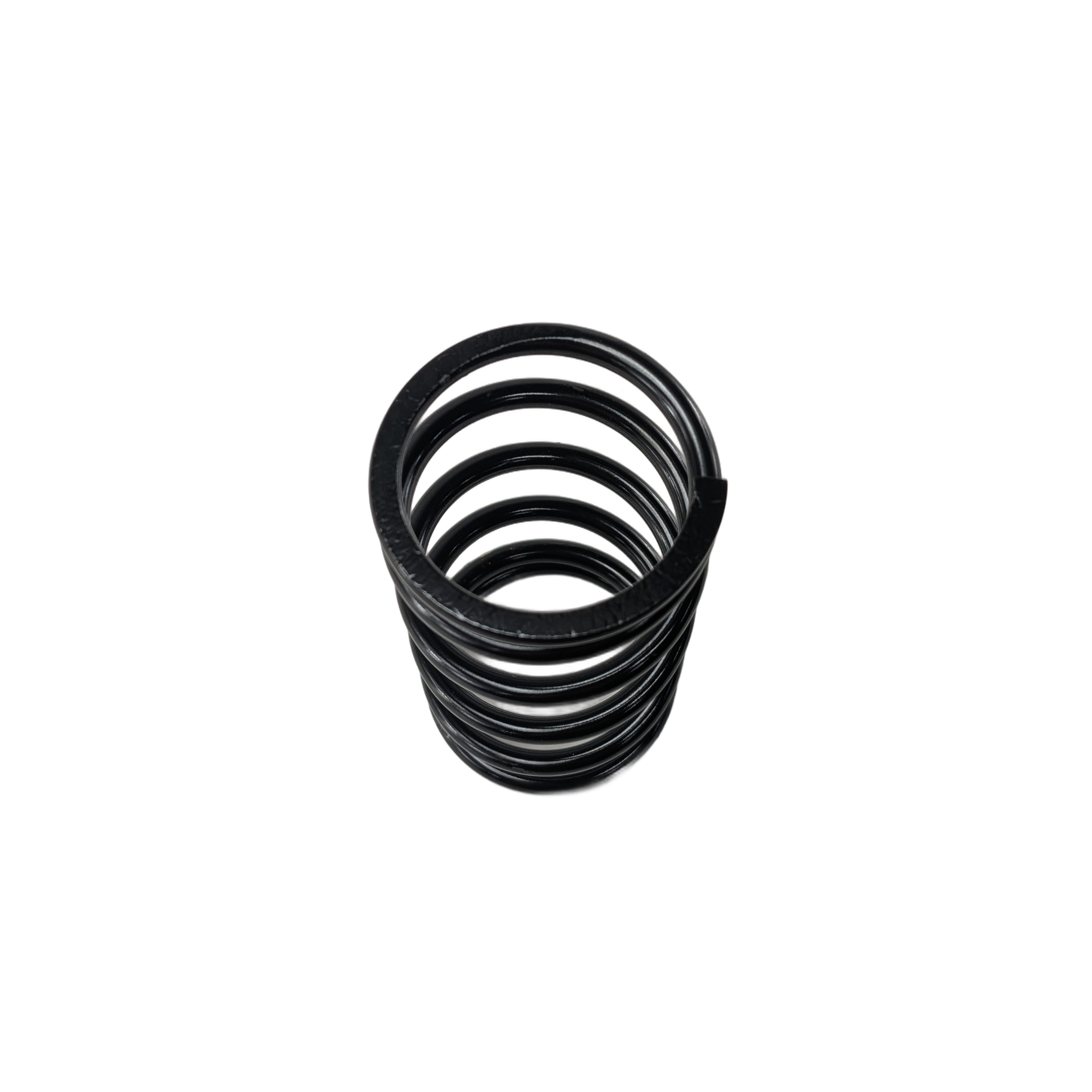 Black coiled metal clutch spring with uniform thickness and tightly wound loops.