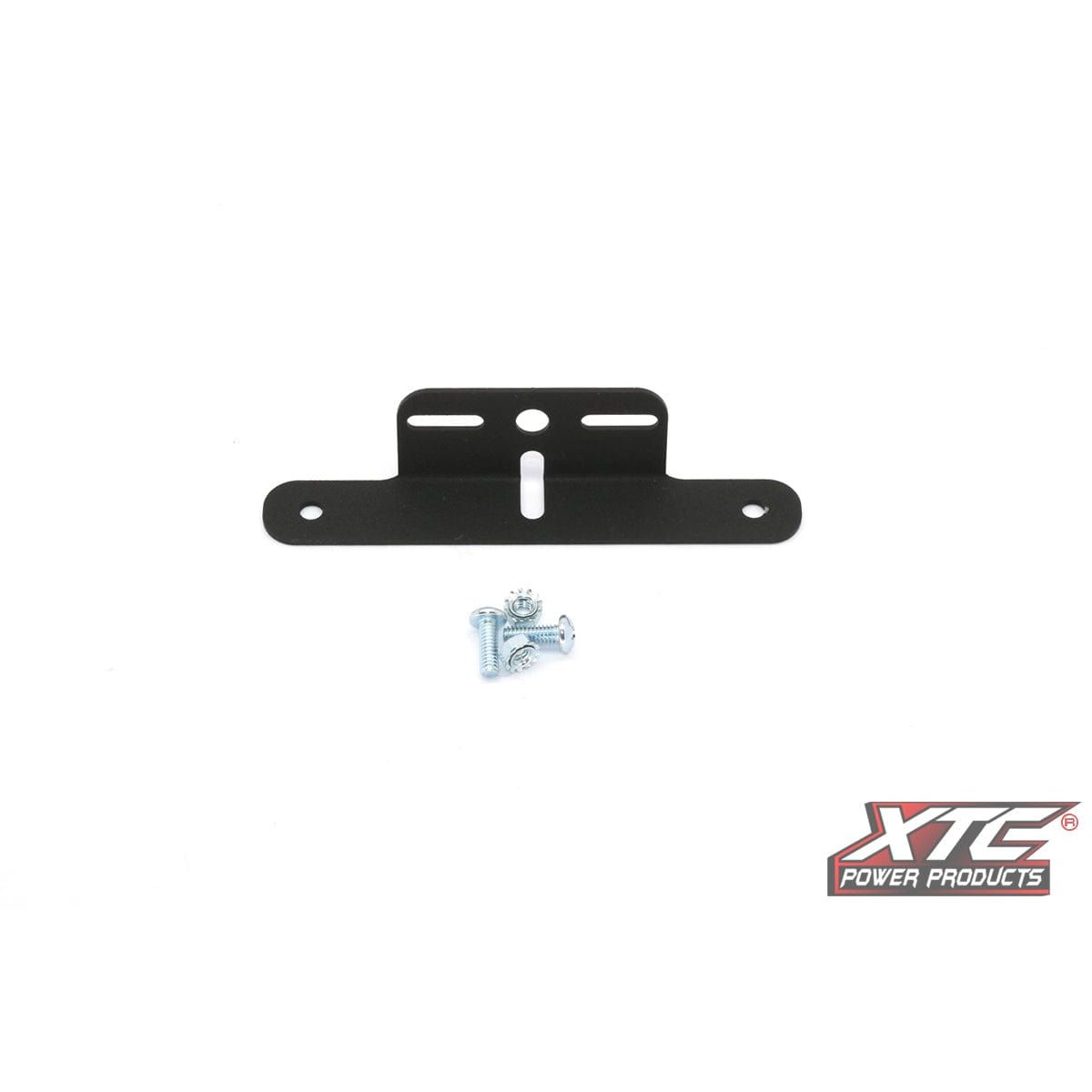 The License Plate Black Universal by XTC Power is a black metal mounting bracket with three slots, two screw holes, and a small set of screws. It features the XTC Power Products logo on a white background and is made in the USA.