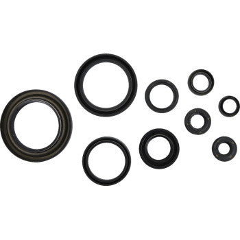 The Honda Crankcase Oil Seal Kit by Cometic includes nine black rubber seals of various sizes, arranged on a white background, perfect for leak repair and ensuring reliable sealing in a range of applications.