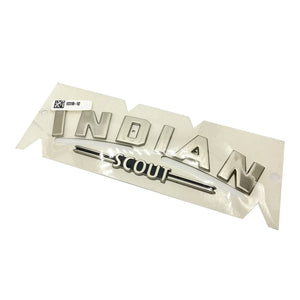 Silver metallic fuel tank badge with raised "INDIAN" text and "SCOUT" script below, polished finish.