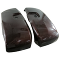 Glossy burgundy OEM motorcycle saddlebag lids with recessed latch openings, curved design.