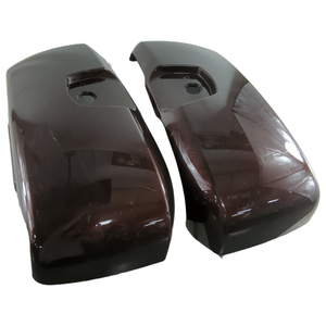 Glossy burgundy OEM motorcycle saddlebag lids with recessed latch openings, curved design.