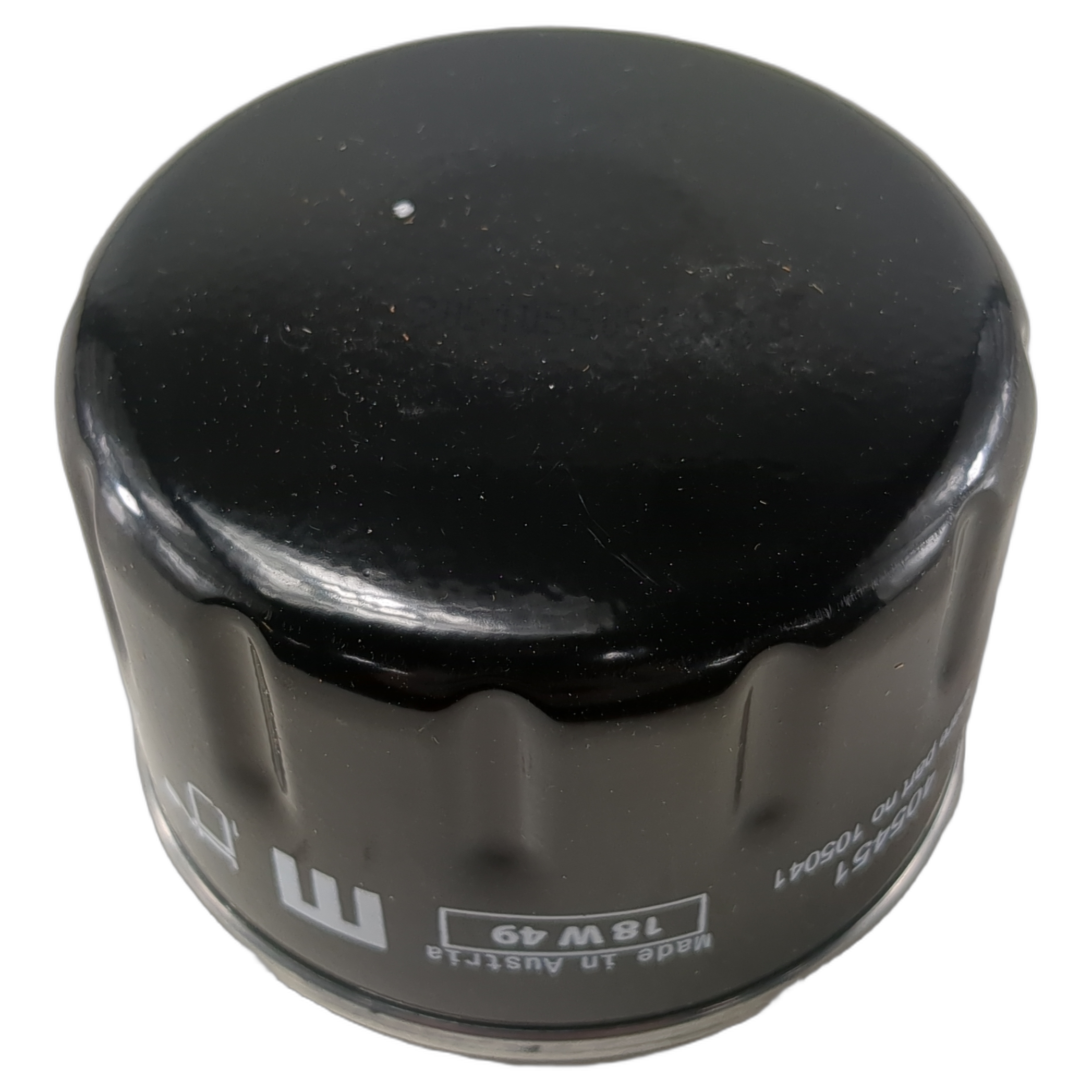 Black cylindrical oil filter with a glossy domed top and white printed markings around its side.
