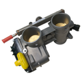 Gray metal dual throttle body with circular openings, yellow cap, and red-tipped actuator arm.