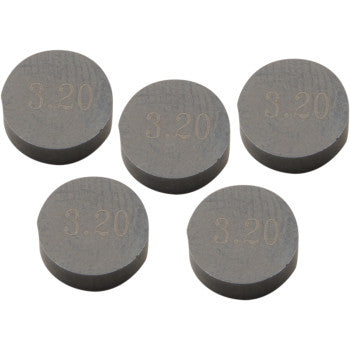 Five round gray metal valve shims, each stamped with "3.20" on the flat surface.