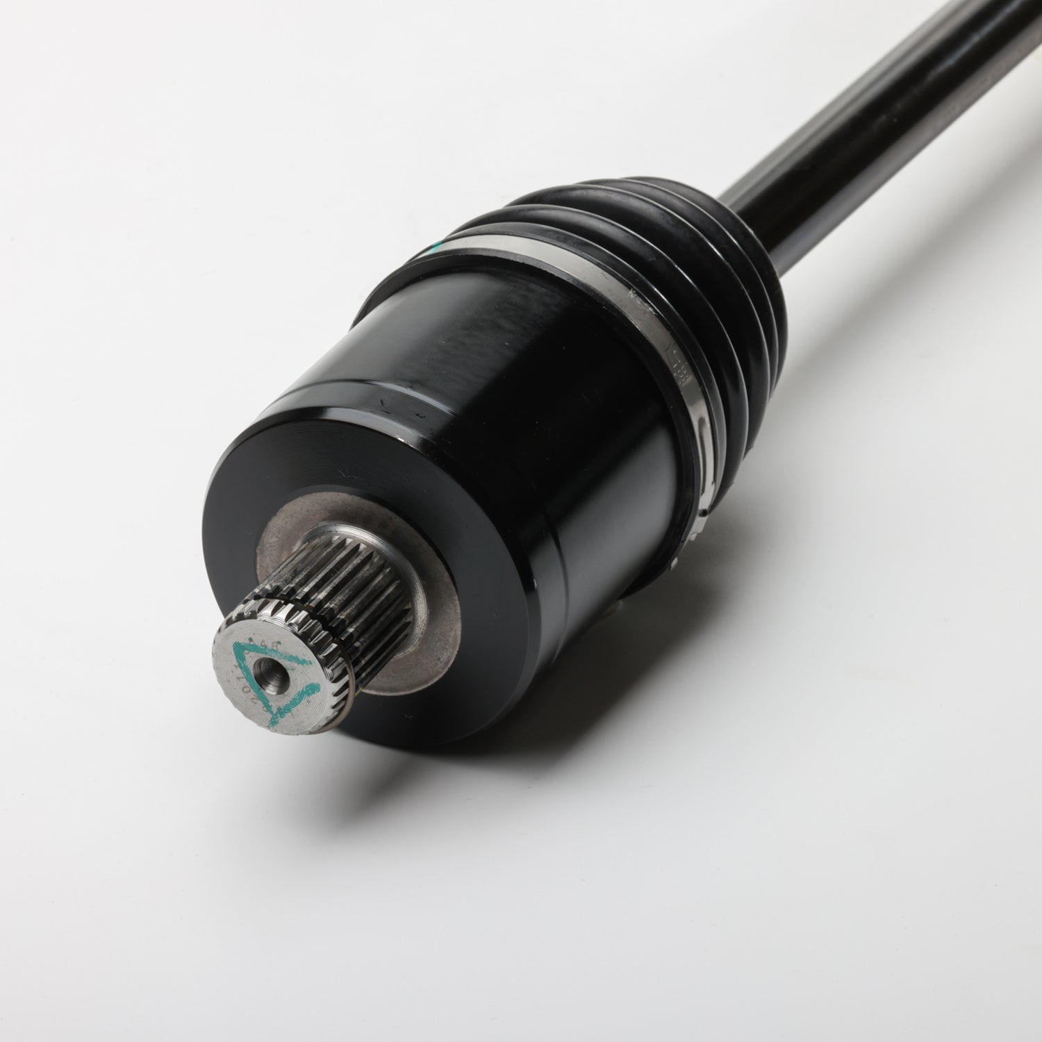 Black metal rear axle shaft with splined end and smooth cylindrical surface.