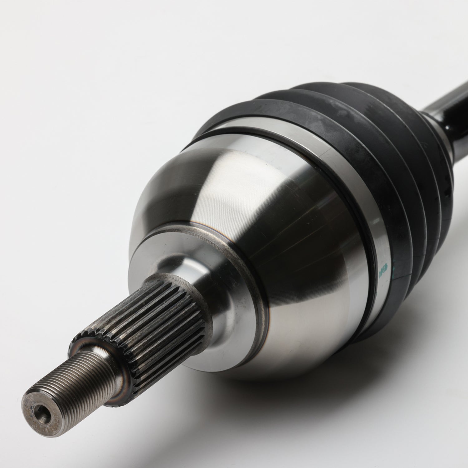 Black and silver metal front CV shaft with ribbed rubber boot and splined shaft end.