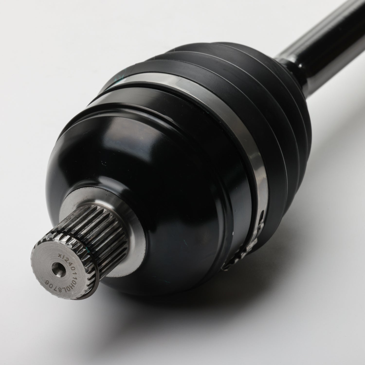 Black metal front CV shaft with ribbed rubber boot and splined end shaft for offroad vehicle.