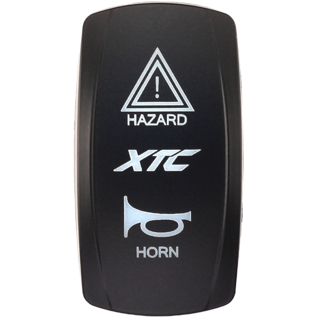 The Dash Switch Rocker Face XTC Hazard/Horn by XTC Power is a black panel featuring a HAZARD warning triangle at the top, XTC in the center, and a HORN icon at the bottom.