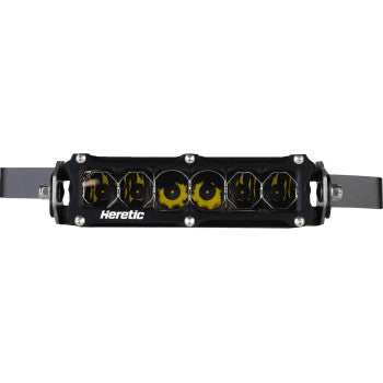 The Light Bar Hood Scoop 6" X 3" by Heretic is a rectangular black LED light bar featuring six yellow CREE LEDs, "Heretic" branding on the front, and CNC aluminum mounting brackets on both sides.