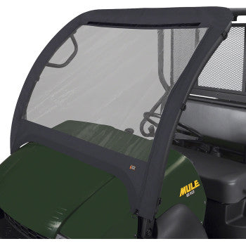 A clear, curved Kawasaki Windshield by Classic Accessories is attached to the front of a green Kawasaki Mule utility vehicle, along with a roll cage enclosure for extra protection of the driver and passenger seats.