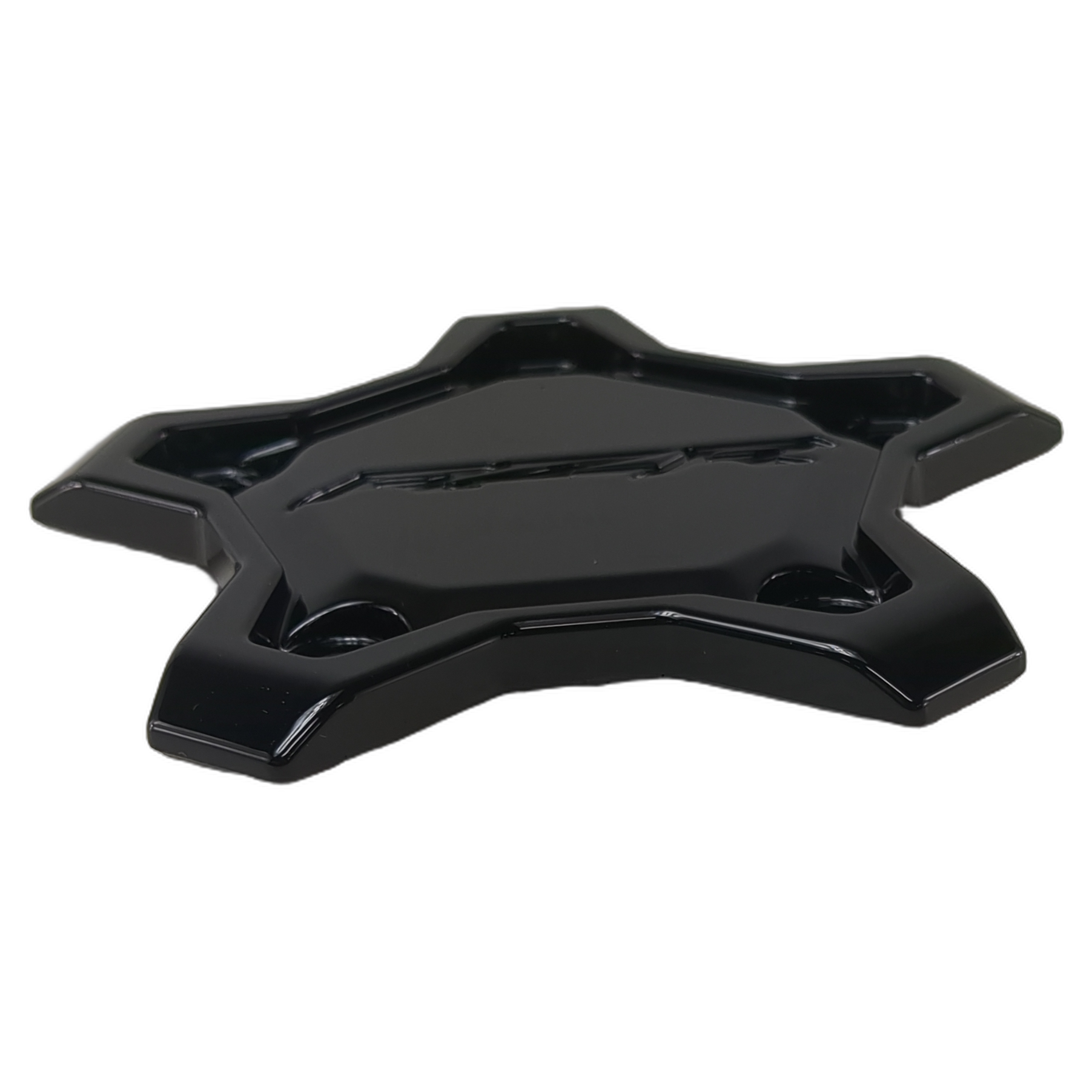 Glossy black star-shaped wheel center cap with raised beadlock design and angular edges.