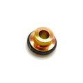 Small brass-colored metal cap with central hole and black rubber seal ring around base.