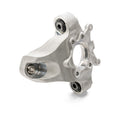 Silver metal rear steering knuckle with circular mounting points and heavy-duty construction.