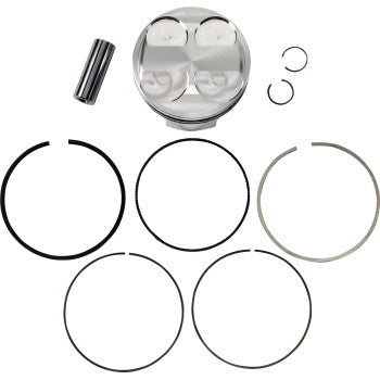 Silver metal piston with four valve reliefs, black and silver piston rings, metal pin, and two small circlips arranged on a.