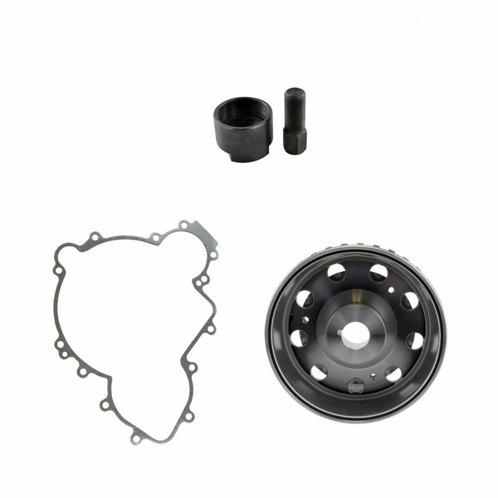 Black cylindrical metal flywheel puller tool with matching bolt, silver gray gasket with multiple mounting holes, and.