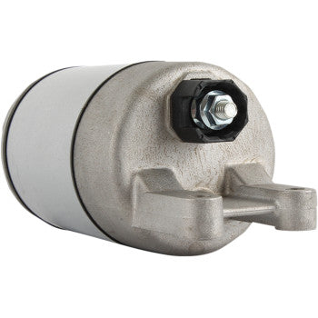 The Suzuki Starter by Parts Unlimited is a metallic cylindrical unit featuring a hexagonal nut and bolt on one end, copper bushings, and a mounting bracket at the base, displayed against a plain white background.