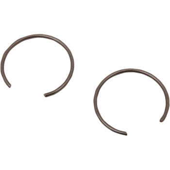 Two small, circular Circlip by Wiseco components with open ends are shown on a white background, made for secure piston installation in high-silicon alloy engines.