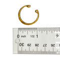 Small metallic gold-colored circular snap ring with open ends, shown next to ruler for size reference.