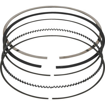 The Vertex Piston Ring Set 94.00 mm OD Replica High Compression Big Bore includes six flat and wavy rings with nitride-coated and chrome-plated finishes, shown stacked in a circle on a white background.