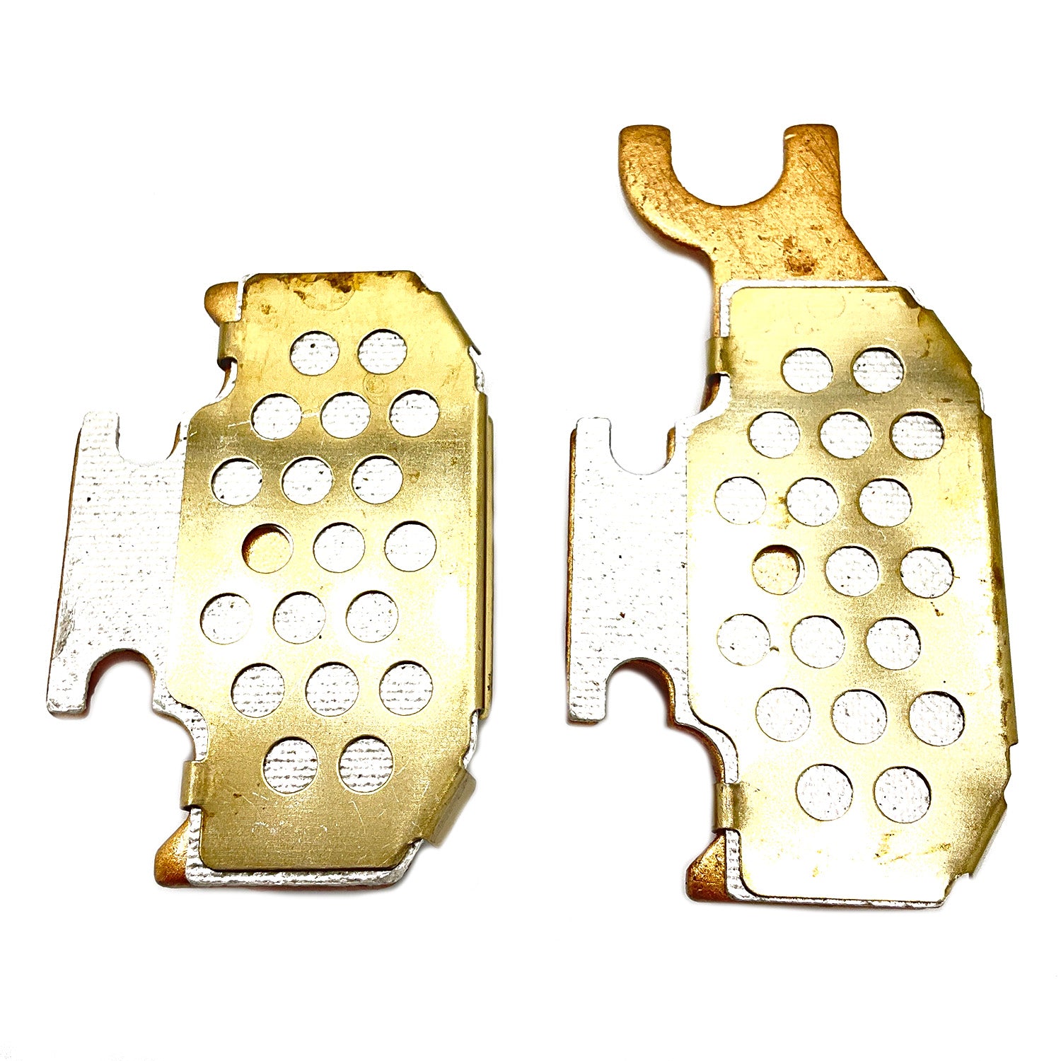 Metallic brake pads with circular perforations, designed for rear use on Polaris ATV models, gold-toned surface.