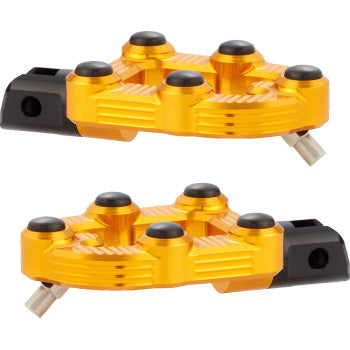 Two gold MX Footpegs - Driver by Arlen Ness, made from billet aluminum with textured surfaces and black grip points, are displayed side by side on a white background, highlighting their bold and stylish design.