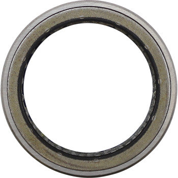 Silver metal clutch bearing with circular shape and smooth outer edge.