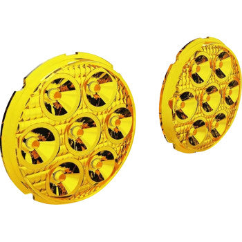 Two Denali D7 Selective Yellow lenses, each round and segmented for improved fog visibility, are displayed on a white background—one facing forward, the other angled.