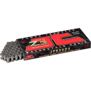 A box labeled 520 Z3 Heavy Duty Drive Chain 110 Links by JT Chains shows a partially visible silver chain on the left. The mainly black packaging is highlighted with red and yellow accents, emphasizing superior quality motorcycle chains.