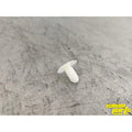 A Trim Button by Can-Am, made of white plastic, rests on a scratched metallic surface. The yellow Can-Am Parts Guy logo in the bottom right corner highlights quality OEM Can-Am parts for your ride.