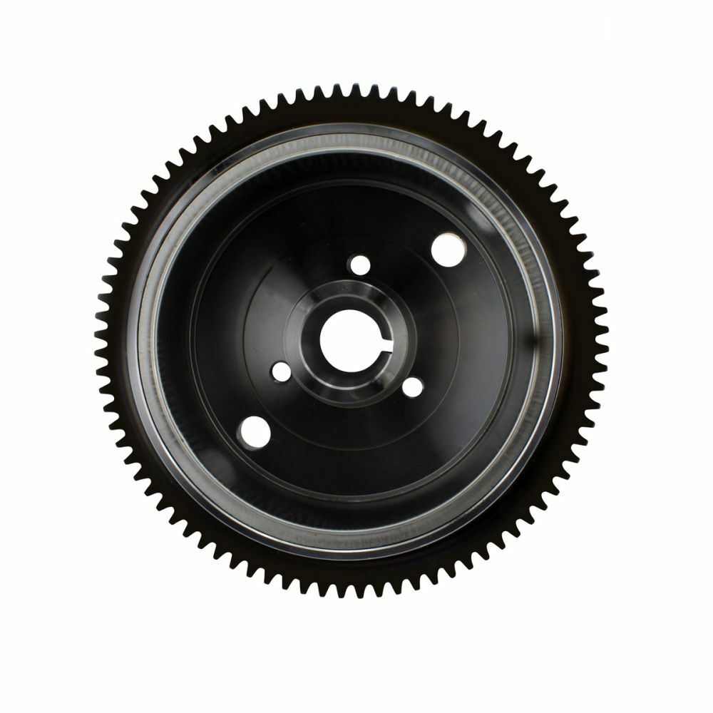 Black circular flywheel with evenly spaced outer gear teeth and multiple inner mounting holes.