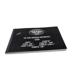 A black owner’s manual for 2009 Kingpin, Vegas, and 8 Ball by Polaris, featuring the Victory Motorcycles logo—perfect for fans or those seeking OEM parts from Witchdoctors.