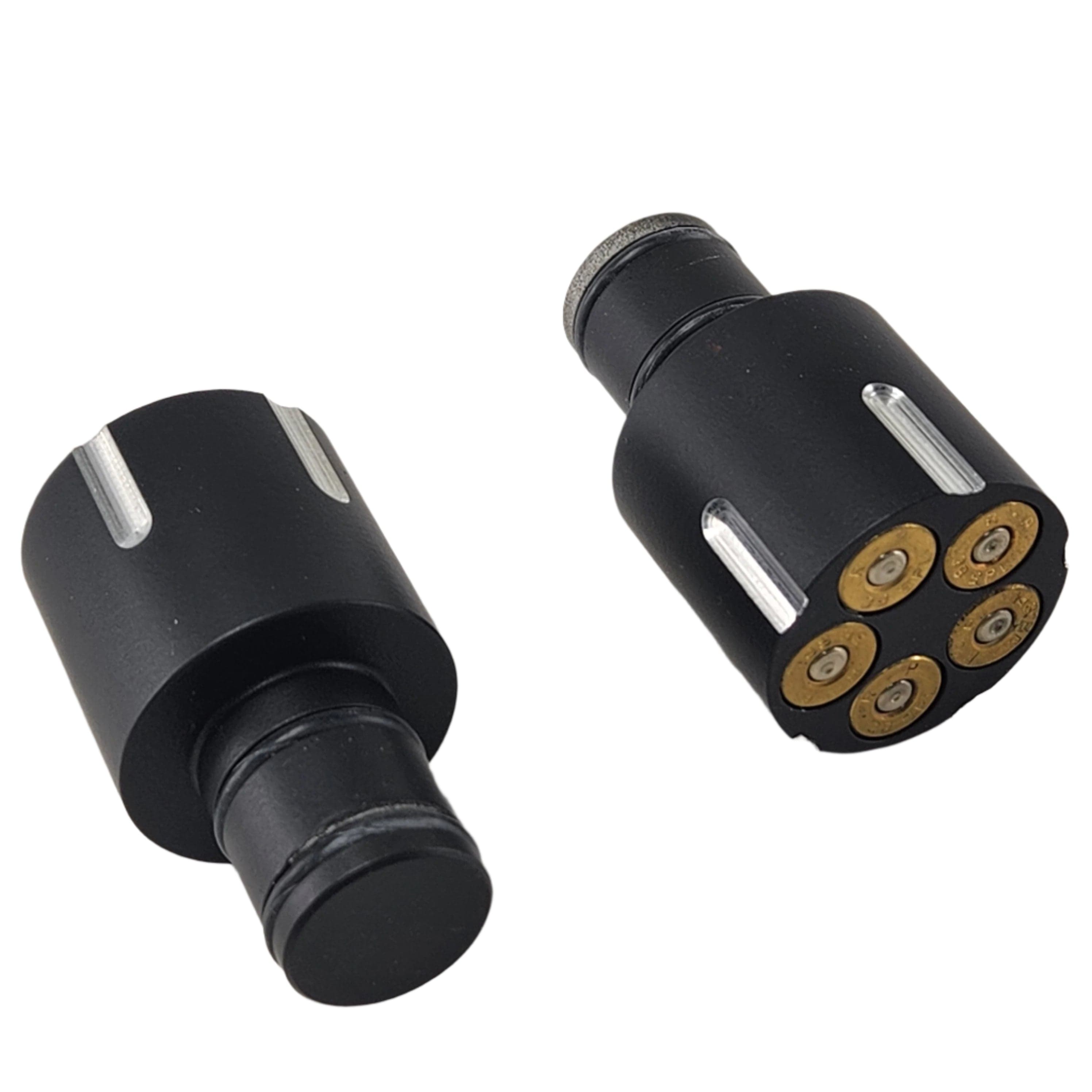 Two black Handlebar End Caps Holeshot by Taylor Specialties, made from billet aluminum—one flat, one upright—feature five brass-colored inserts at the base reminiscent of a revolver cylinder; compatible with Victory motorcycles.