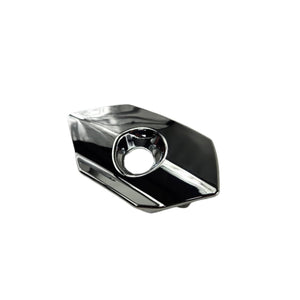 The Bezel Lock Cover Left Hand Chrome by Polaris is an OEM chrome metal saddlebag lock bezel for Victory motorcycles, featuring an angular design with a central hole, shown on a white background.
